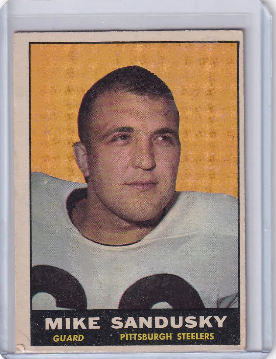 Vintage 1961 Topps Football card of Mike Sandusky from Pittsburgh Steelers on orange background