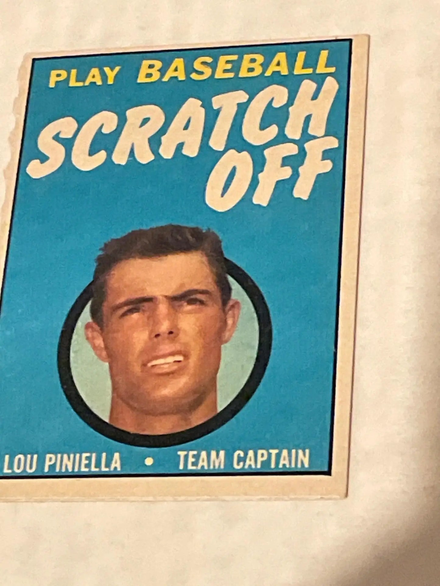 Vintage Topps Baseball trading card of team captain Lou Pinella on turquoise background