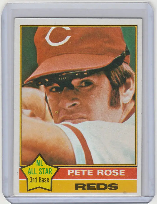 Baseball card of Pete Rose Cincinnati Reds in red cap from 1976 Topps NRMT collection