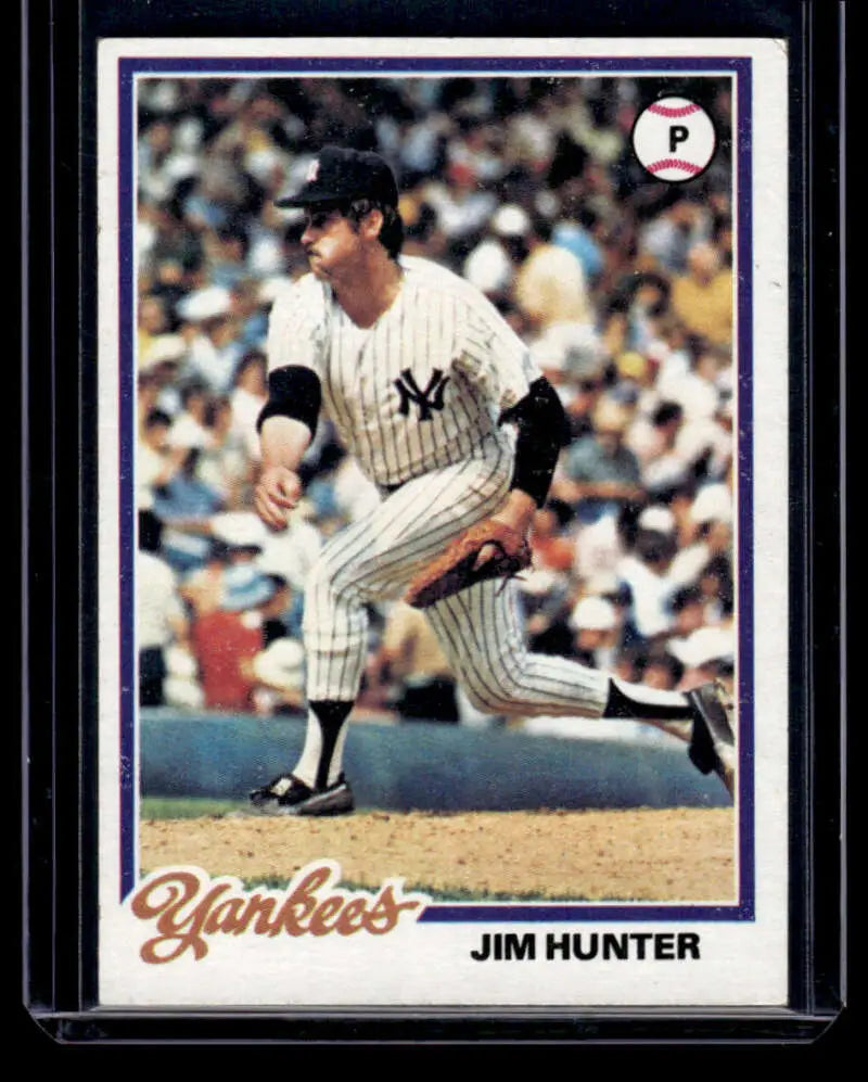 Baseball card of Jim Hunter in pinstripes for the New York Yankees mid-delivery