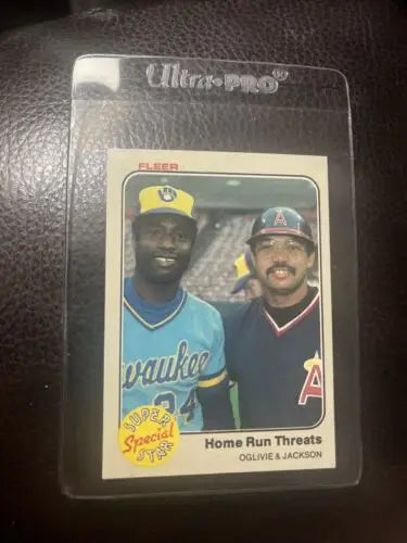 Baseball card in protective case for 1983 Fleer Reggie Jackson, Ben Oglivie HOF sports trading card