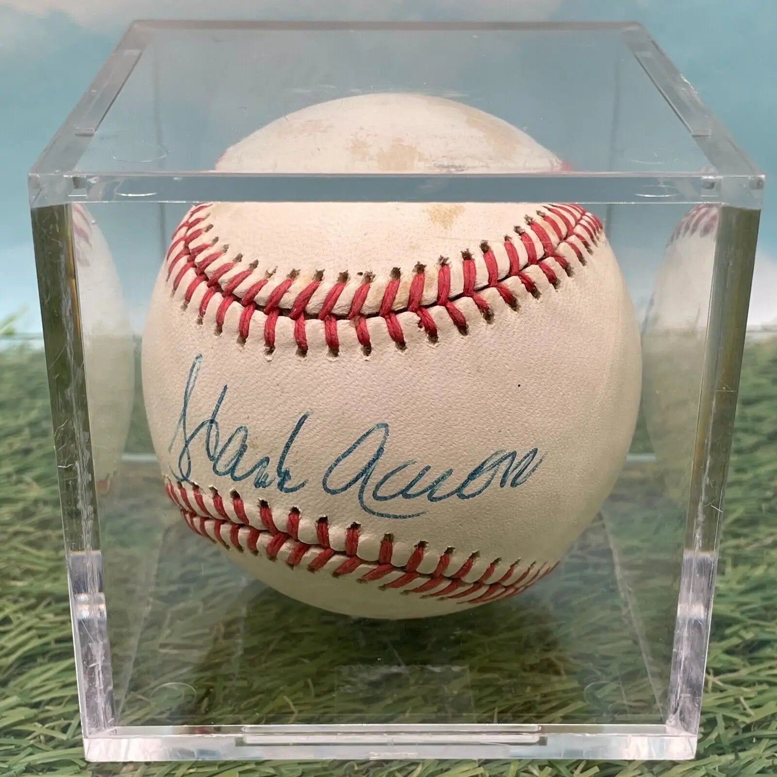 Hank Aaron autographed baseball in a clear case for Atlanta Braves collectors