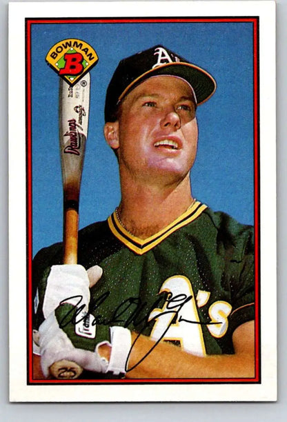 Mark McGwire in Oakland Athletics uniform with bat against blue sky for baseball card