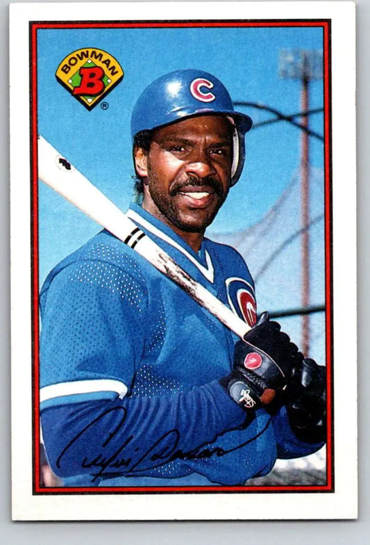 Smiling Andre Dawson in Chicago Cubs uniform holding bat on baseball card