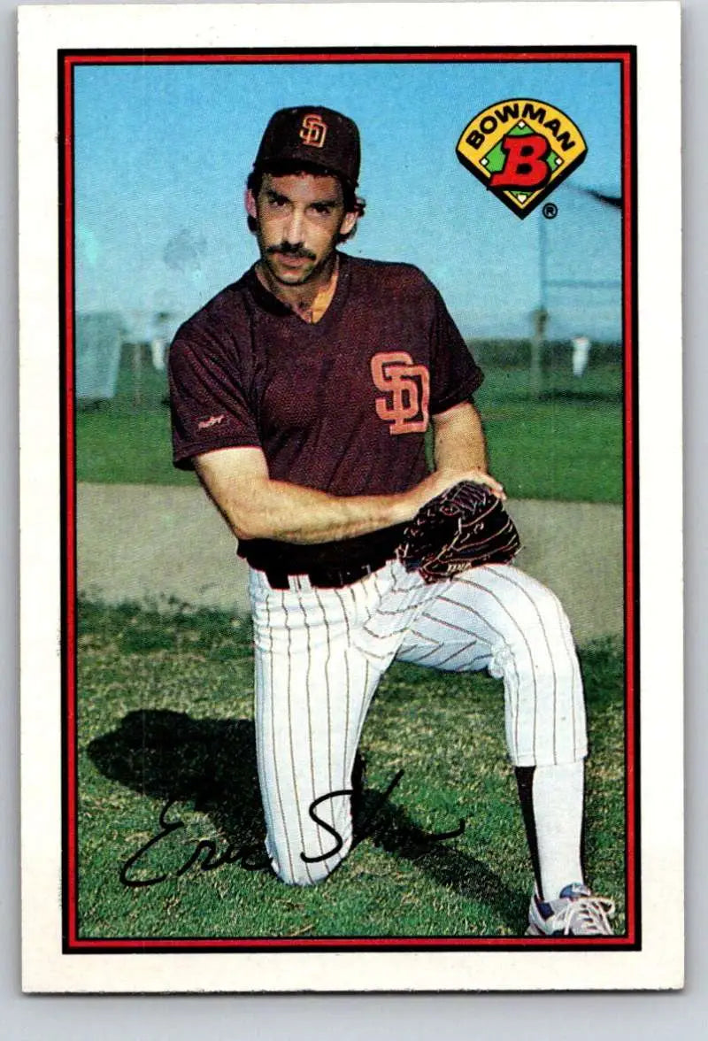 Baseball player in San Diego Padres pinstriped uniform posing in pitching stance