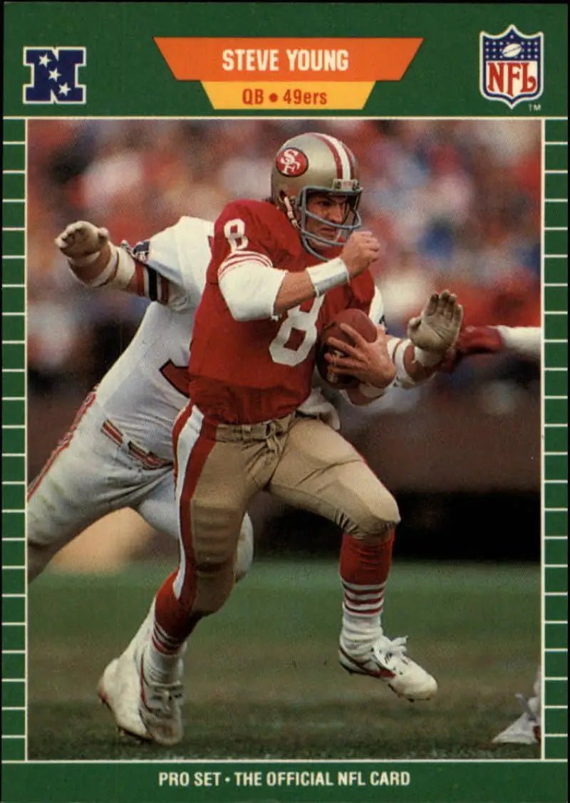 San Francisco 49ers quarterback Steve Young in red uniform carrying football card