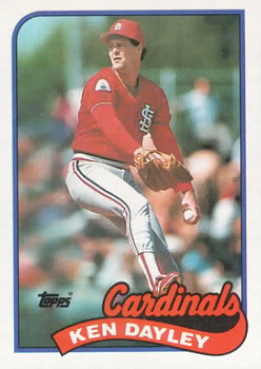 Baseball card of Ken Dayley in red uniform for St. Louis Cardinals mid-delivery