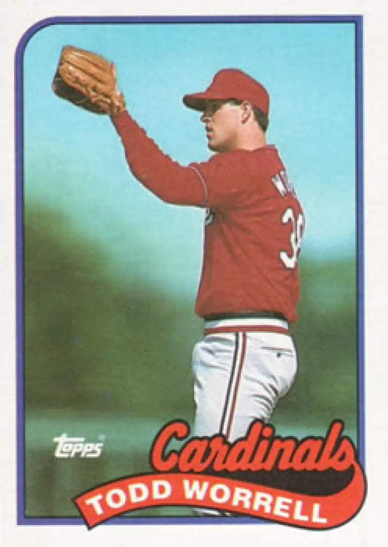 Baseball card of Todd Worrell in red jersey for St. Louis Cardinals reaching with glove