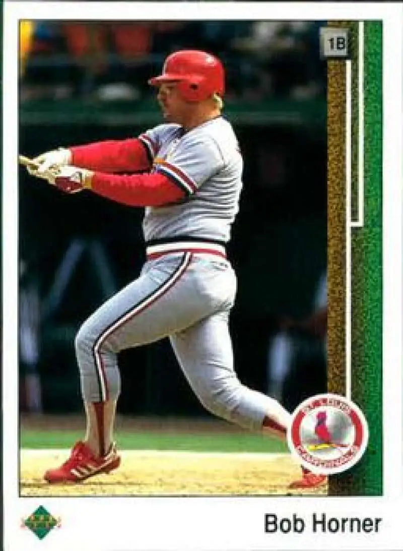 Baseball player in St. Louis Cardinals uniform swinging bat on Bob Horner baseball card