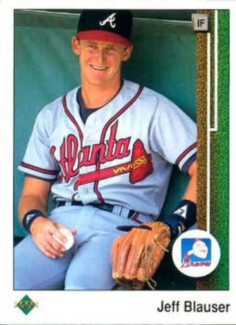 Jeff Blauser in Atlanta Braves uniform sitting in dugout with glove and baseball