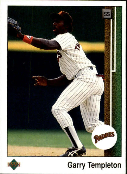 Baseball player in white pinstriped San Diego Padres uniform fielding ball, Garry Templeton