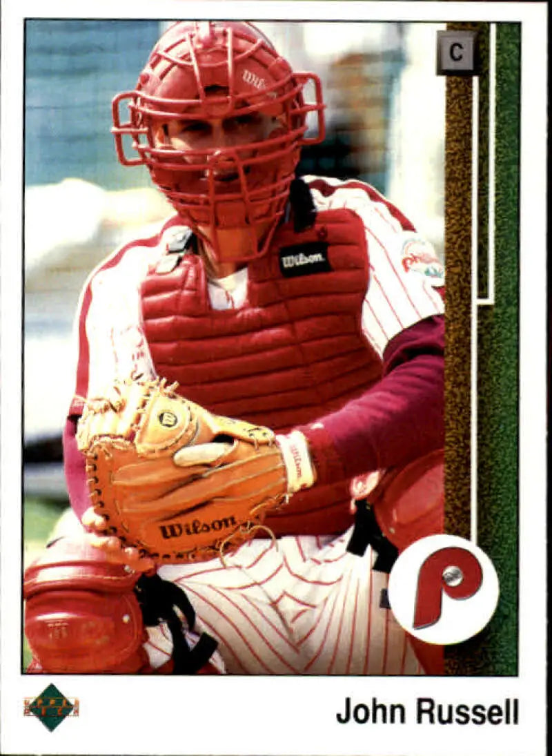 Baseball catcher in red gear with mitt, featuring John Russell Upper Deck baseball card