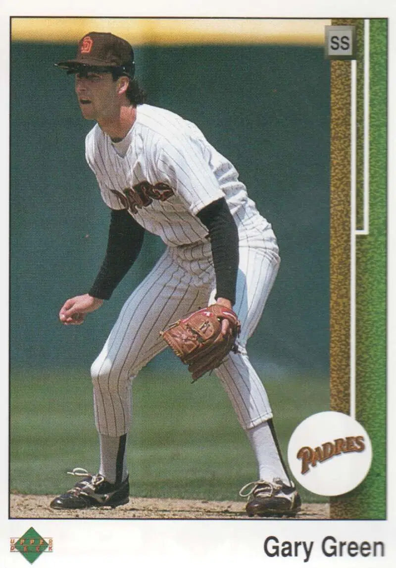 Baseball player in San Diego Padres pinstriped uniform fielding stance