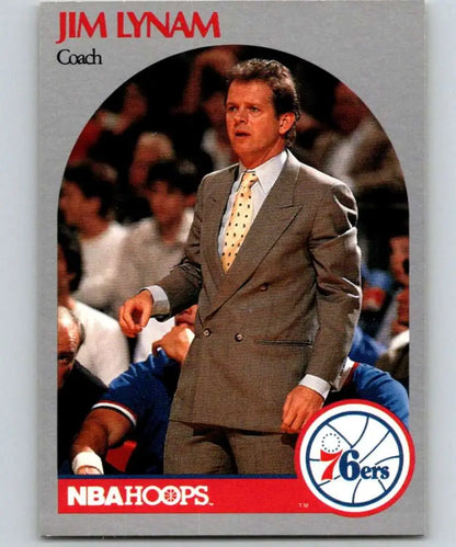 Jim Lynam coaching on the sidelines in a gray suit for Philadelphia 76ers Basketball