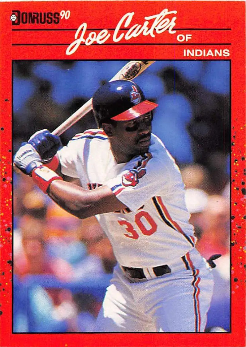 Red 1990 Donruss baseball card of Joe Carter from the Cleveland Indians displayed