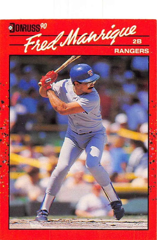 Red 1990 Donruss baseball card of Fred Manrique, Texas Rangers player at bat