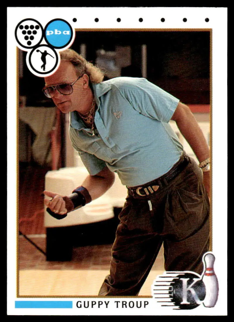 A bowler in a light blue shirt ready to release a shot from the Guppy Troup PBA Bowling Card