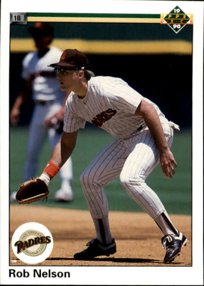 Baseball player Rob Nelson fielding at first base in San Diego Padres uniform