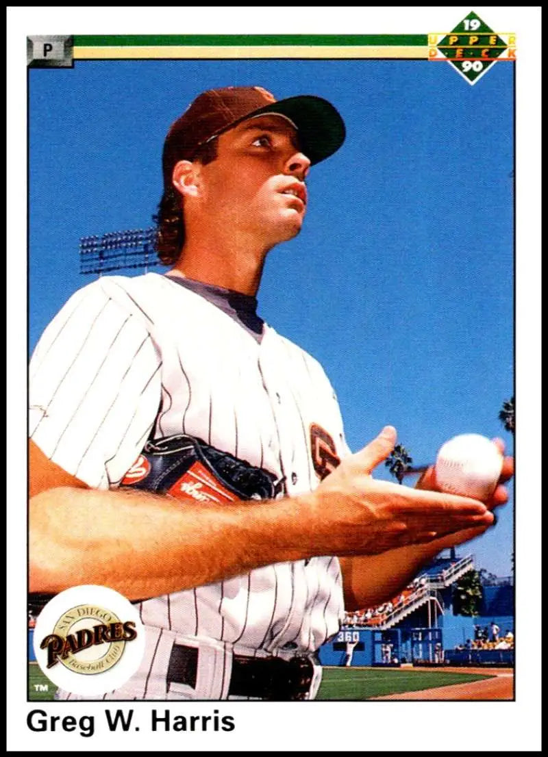 Greg Harris in white pinstriped uniform holding a baseball for San Diego Padres