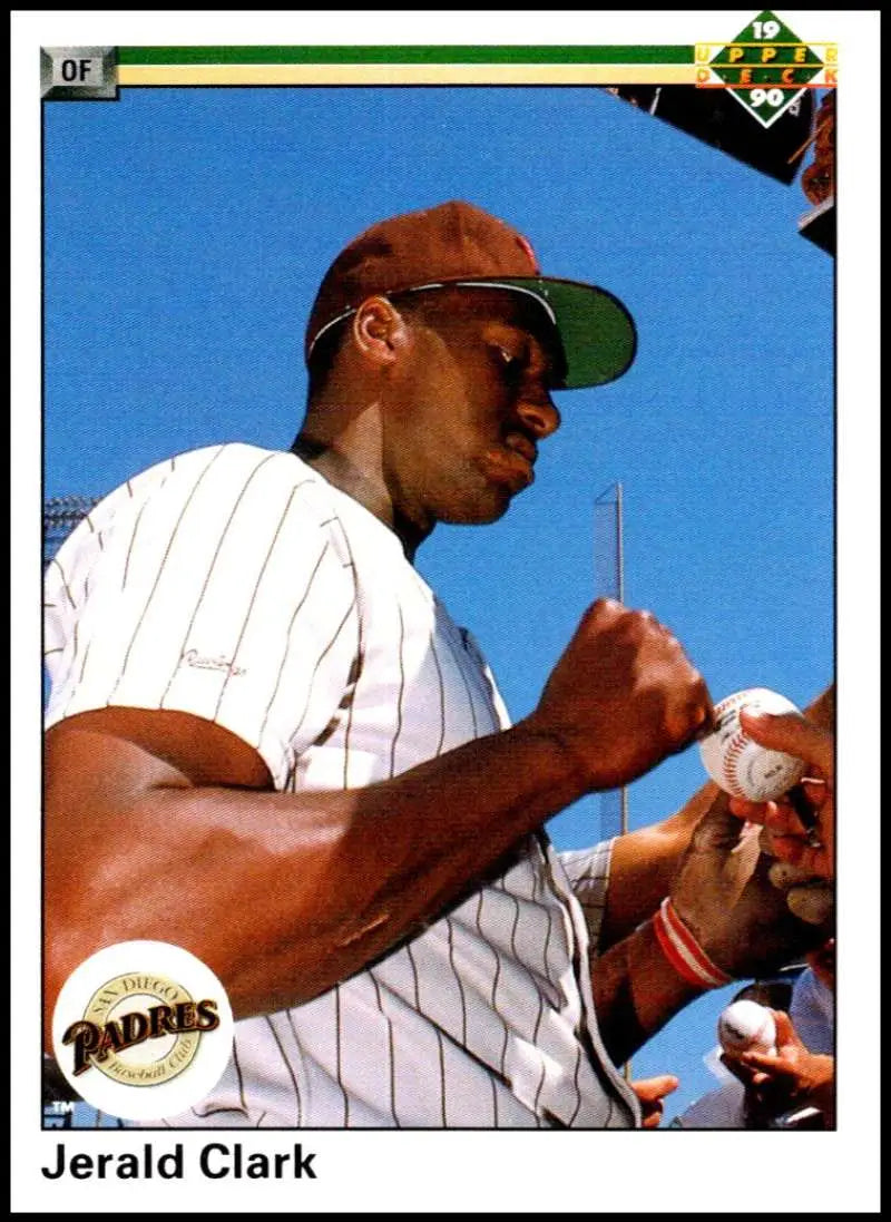 Baseball player in white pinstriped Padres uniform signing autographs, Jerald Clark