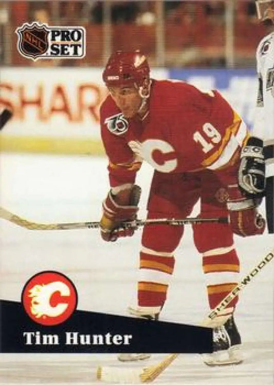 Hockey player in red Calgary Flames jersey number 19 on Tim Hunter hockey card