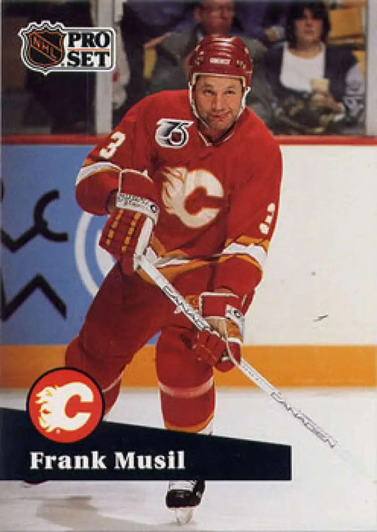 Hockey player in red Calgary Flames jersey skating with stick for Frank Musil hockey card