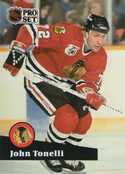 John Tonelli in a red Chicago Blackhawks jersey showcasing hockey action on ice