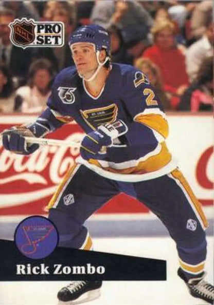 Hockey player in St. Louis Blues jersey showcasing Rick Zombo card for San Jose Sharks