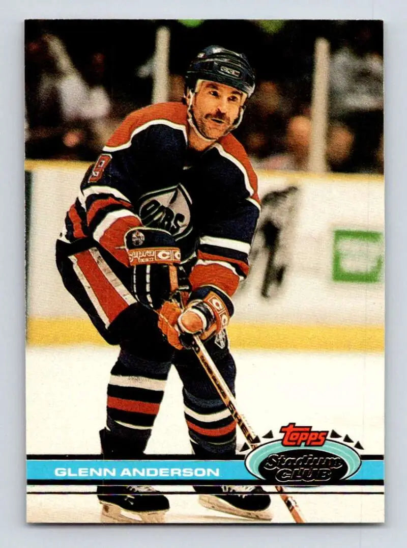 Hockey player in dark jersey with orange stripes from Edmonton Oilers Glenn Anderson card