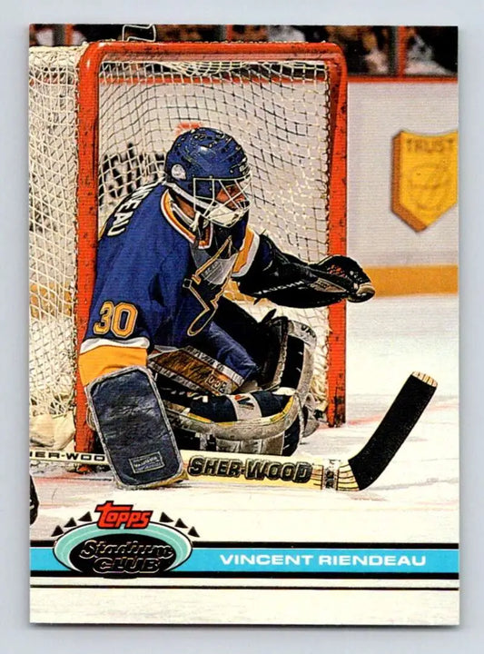 Hockey goalie Vincent Riendeau in blue jersey making a save for Louis Blues hockey card