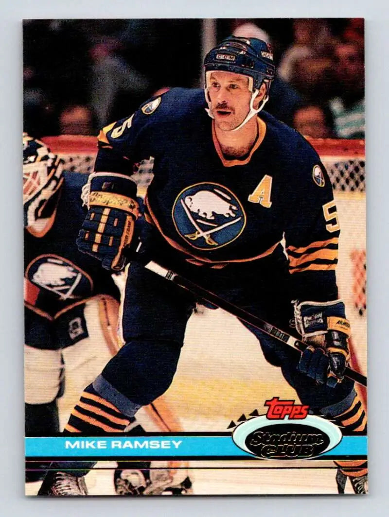 Buffalo Sabres player in blue and gold jersey during gameplay, Topps Stadium Club card