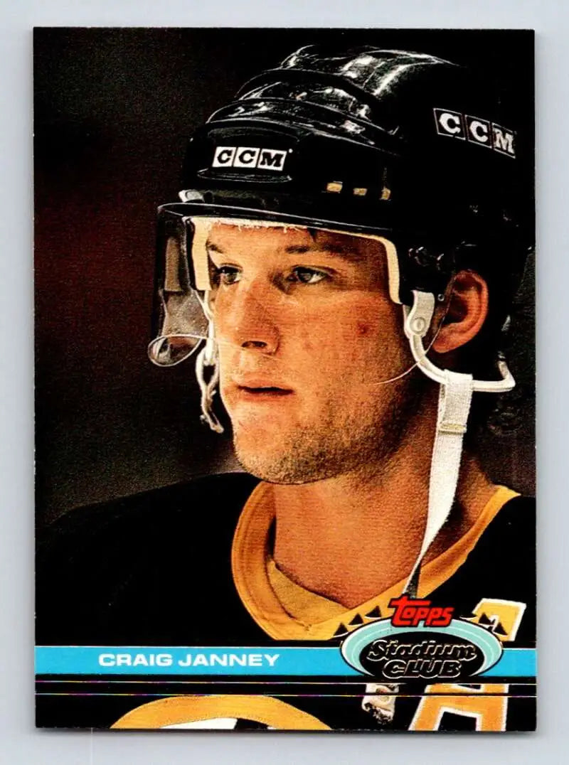 Hockey player in black CCM helmet and yellow jersey for Boston Bruins Stadium Club card