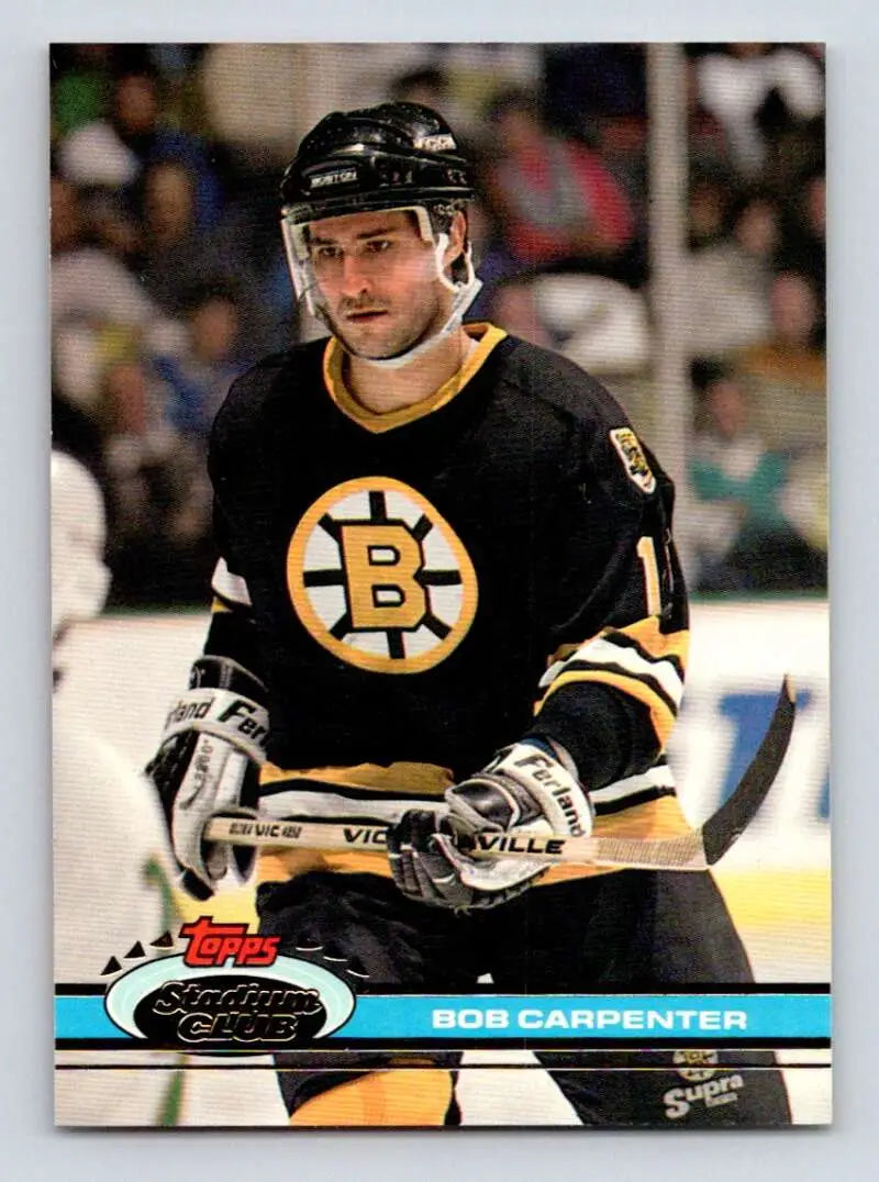 Hockey player in Boston Bruins jersey showcasing Bob Carpenter Stadium Club card