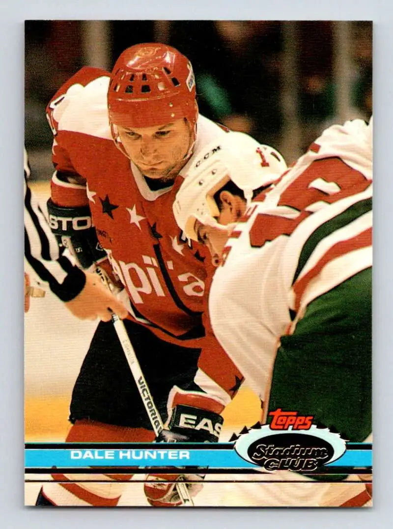 Hockey card of Dale Hunter from the Washington Capitals in a red jersey facing an opponent