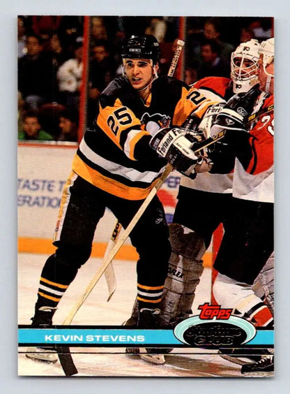 Hockey card of Kevin Stevens skating for the Pittsburgh Penguins in black and gold uniform