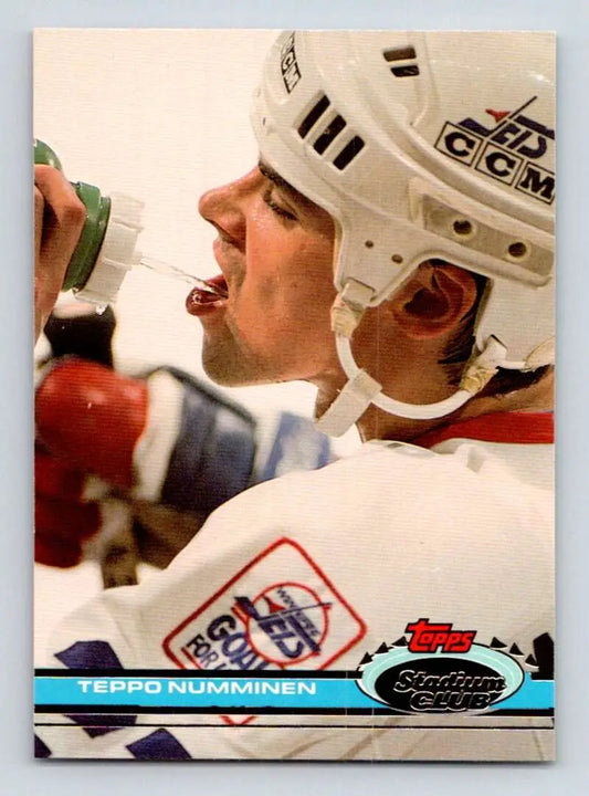 Hockey player in white helmet and jersey on 1991-92 Topps Winnipeg Jets card featuring Teppo Numminen