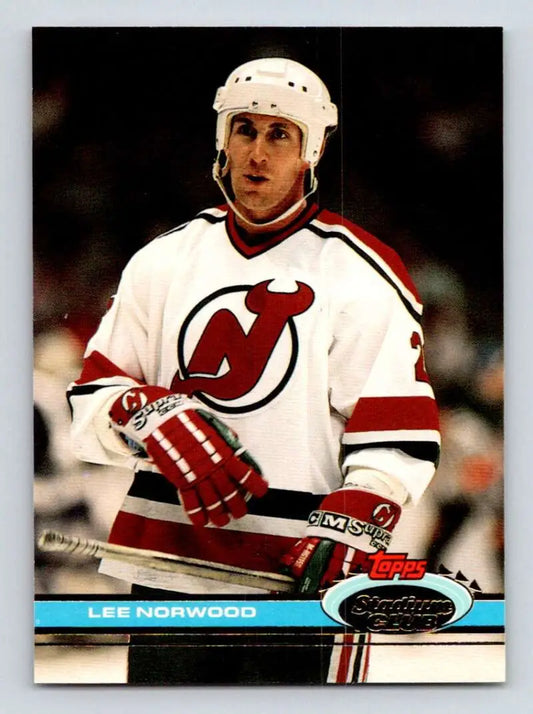 Hockey player in New Jersey Devils jersey showcasing Lee Norwood Stadium Club card