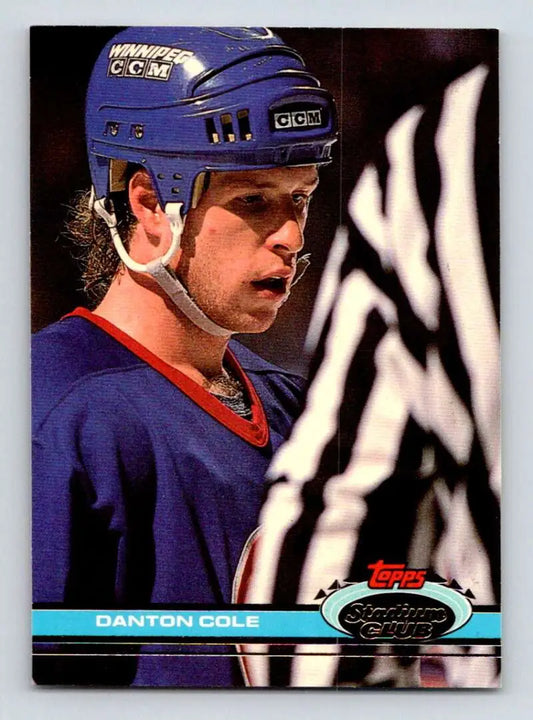 Hockey player Danton Cole in a blue helmet talks to a referee for Winnipeg Jets Stadium Club