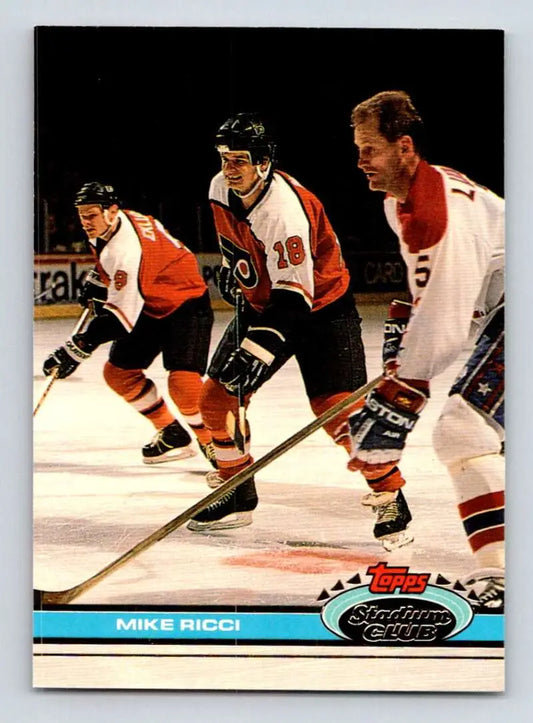 Hockey players in orange and white jerseys during a game on a Mike Ricci Topps Stadium Club card