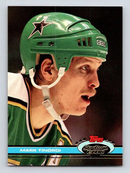 Hockey player in green Dallas Stars helmet, featuring Mark Tinordi of Minnesota North Stars