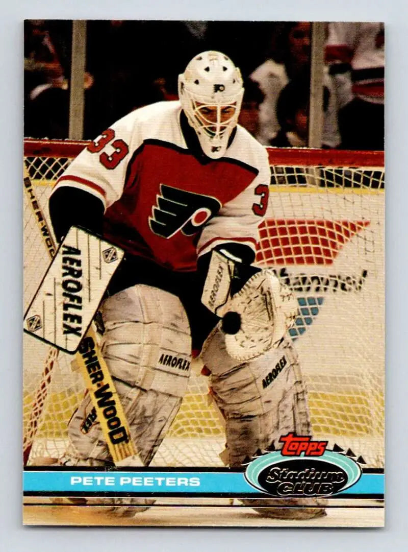 Pete Peeters of Philadelphia Flyers in red jersey and white mask on hockey card