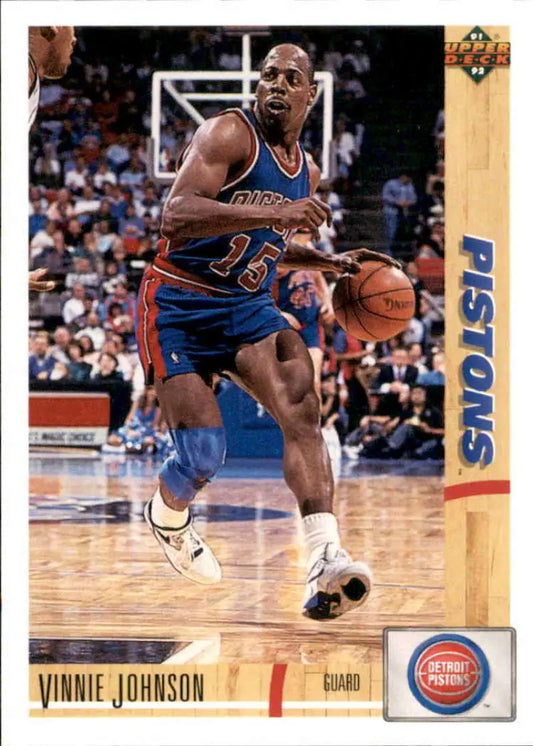 Basketball card of Vinnie Johnson dribbling in Detroit Pistons blue uniform