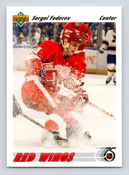 Hockey player in Detroit Red Wings jersey making a turn, showcasing Sergei Fedorov’s skill