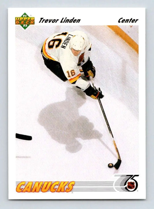 Hockey player in white Canucks jersey controlling puck for Trevor Linden Upper Deck card