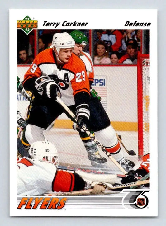 Hockey player in Philadelphia Flyers jersey skating with puck on Terry Carkner card