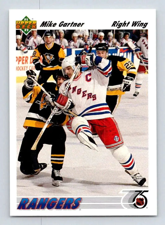 Hockey trading card featuring Mike Gartner of the New York Rangers in puck battle action