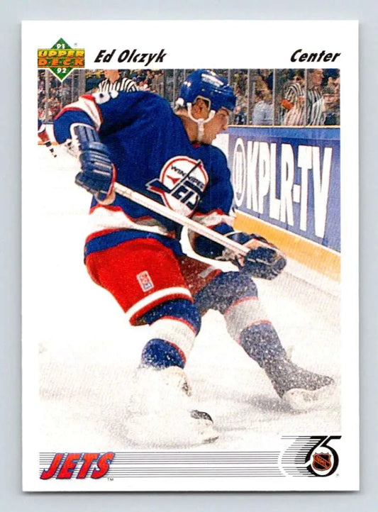 Hockey player in Winnipeg Jets uniform skating along the boards for Upper Deck card