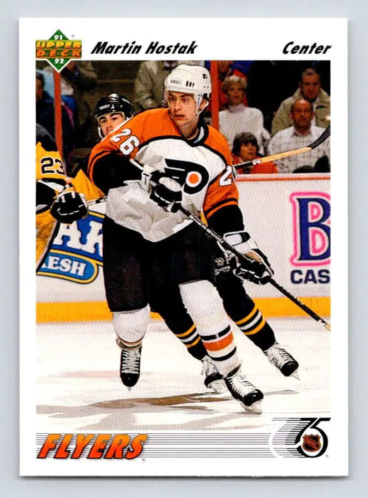 Hockey player Martin Hostak skating in Philadelphia Flyers uniform on ice