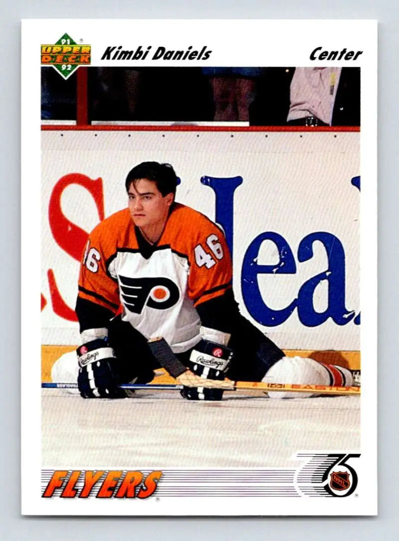 Philadelphia Flyers player Kimbi Daniels in orange and white jersey stretching on ice