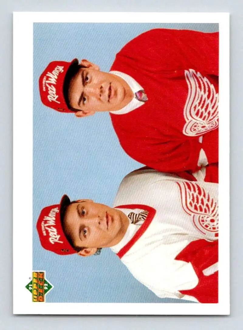 Two Detroit Red Wings players in jerseys and caps on a classic sports card photo